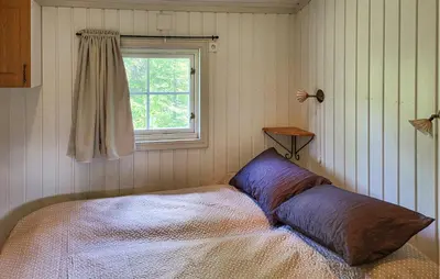 a bed in a room with a window at 2 Bedroom Nice Home In Hafjell in Hafjell