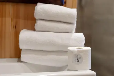a stack of white towels sitting on top of a toilet at Trysilfjell 25 by Vacation Trysil in Trysil