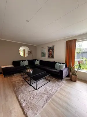 a living room with a couch and a table at Martine's home in Lii