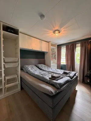 a bedroom with a large bed with aabinet at Martine's home in Lii