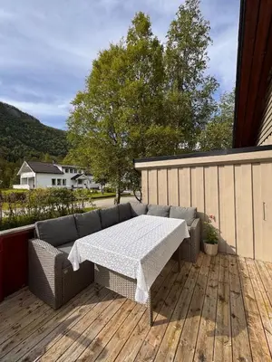 a patio with a table and a couch on a deck at Martine's home in Lii