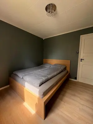 a bedroom with a bed in a green wall at Martine's home in Lii