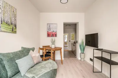 a living room with a green couch and a table at City Apartment I Cozy with Perfect Location in Bergen