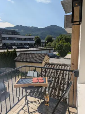 a patio with a table and chairs on a balcony at Apartment in the middle of the city center in a quiet street in Stryn