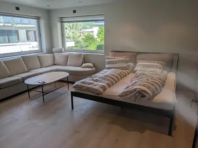 a couch and a table in a living room at Apartment in the middle of the city center in a quiet street in Stryn