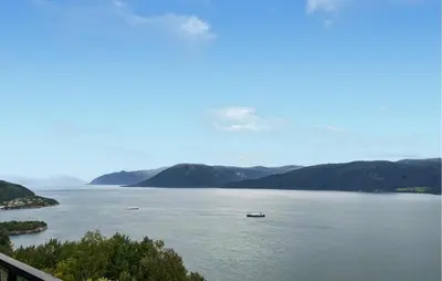 a view of a large body of water with a boat in it at Stunning Home In Lavik in Lavik