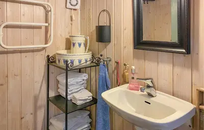 a bathroom with a sink and a mirror and a towel rack at Stunning Home In Lavik in Lavik