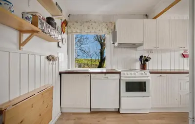 a kitchen with white appliances and a window at Amazing Home In Rong With Ethernet Internet in Rong