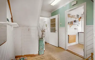 a hallway with a white door and a vase at Amazing Home In Rong With Ethernet Internet in Rong