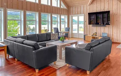 a large living room with couches and tables and windows at Pet Friendly Home In Eidsvåg I Romsdal in Eidsvåg