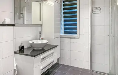 a white bathroom with a sink and a shower at Pet Friendly Home In Eidsvåg I Romsdal in Eidsvåg