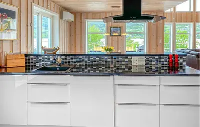 a kitchen with white cabinets and a sink at Pet Friendly Home In Eidsvåg I Romsdal in Eidsvåg