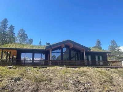 a house with a grass roof on top of a hill at Moderne og romslig familiehytte i Stryn in Stryn