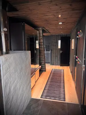 a hallway with a rug on the floor of a house at Hytte på Norefjell in Surteberg