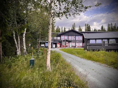 a barn with a road in front of it at Hytte på Norefjell in Surteberg