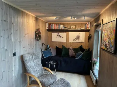 a living room with a couch and a chair at MYLLA - New cabin - Sauna - Hike - Bike - Canoe- Fishing in Jevnaker