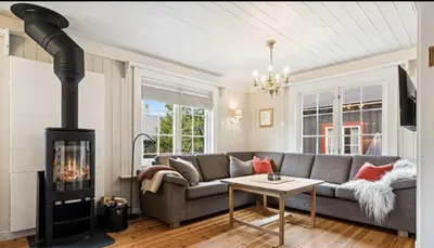a living room with a couch and a wood stove at Cabin with ski in-out in Sør-Fron