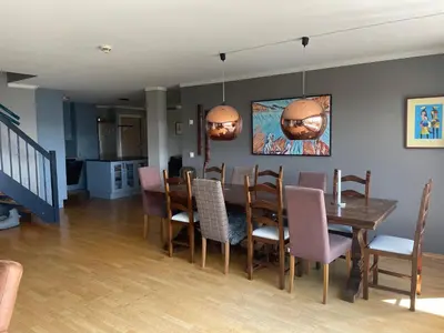 a dining room with a table and chairs at Stor Toppleilighet I Sentrum in Beitostøl