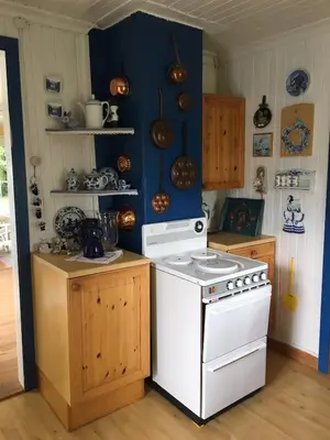 a kitchen with a white stove and blue walls at Welcome to Dalborg, only 1,5 hours from Oslo