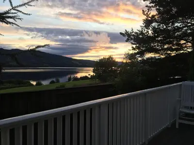 a view of a lake at sunset on a balcony at Welcome to Dalborg, only 1,5 hours from Oslo