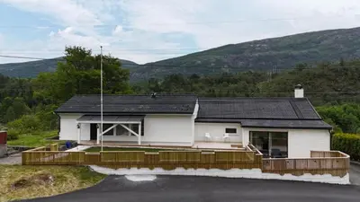 a white house with a wooden fence around it at Apartment in Bergen in Bergen