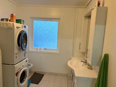 a bathroom with a sink and a washing machine at Apartment in Bergen in Bergen