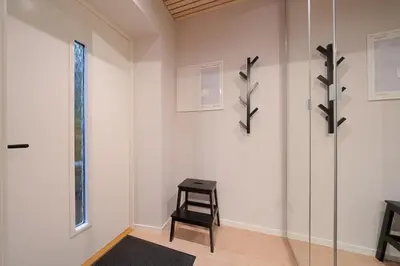 a room with a stool and a glass wall at EasyStay Nesttun -Free Parking-Buss Nearby - in Bergen