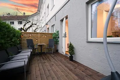 a deck with chairs and a table on a house at EasyStay Nesttun -Free Parking-Buss Nearby - in Bergen