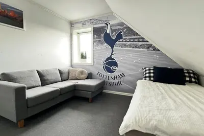 a living room with a couch and a wall mural at Nordic Villa Retreat in Ålesund
