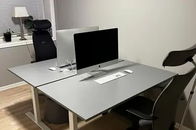 a desk with a computer monitor on top of it at Nordic Villa Retreat in Ålesund