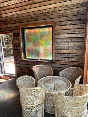 a room with a table and chairs in a cabin at Forest Hideaway With Scenic View in Fiskå