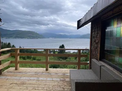 a porch with a view of a lake at Forest Hideaway With Scenic View in Fiskå