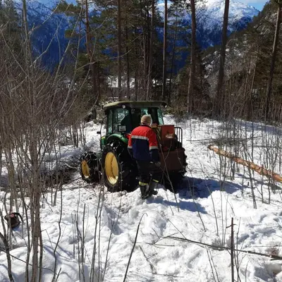 a man riding a tractor in the snow at Standard Hytte in Fjæra