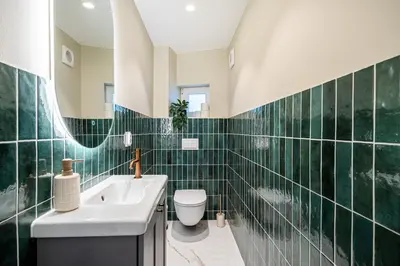 a bathroom with a sink and a toilet and a mirror at The Townhouse Dream I No Expense Spared I NEW 2025 in Bergen