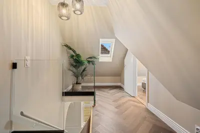 a staircase in a house with a potted plant at The Townhouse Dream I No Expense Spared I NEW 2025 in Bergen