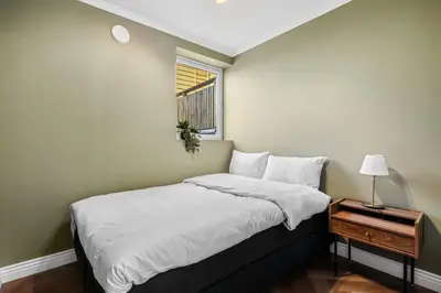 a small bedroom with a bed with a window at The Townhouse Dream I No Expense Spared I NEW 2025 in Bergen