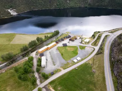 an aerial view of a farm with a lake at Standard Rom in Fjæra