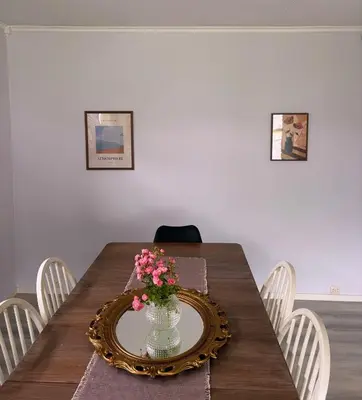 a dining room table with a vase of flowers on it at House in Nordfjord, with 4 bedrooms in Nordfjordeid