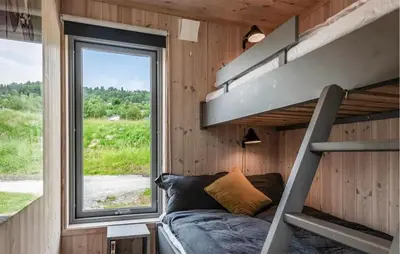 a bunk bed in a tiny house with a window at Lovely Home In Ål With House Sea View in Ål