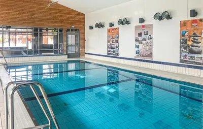 a large swimming pool with blue water at Amazing Apartment In Bjorli With Sauna in Bjorli