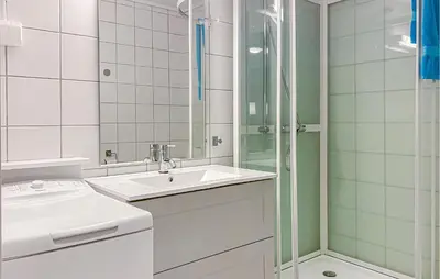 a white bathroom with a sink and a shower at Amazing Apartment In Bjorli With Sauna in Bjorli