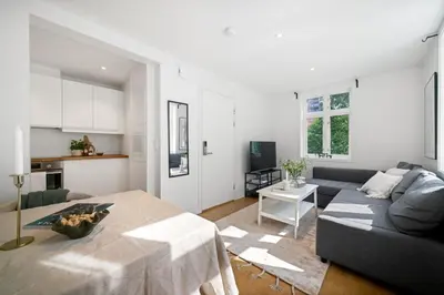 a living room with a couch and a table at Modern apartment near bryggen - classic architecture in Bergen