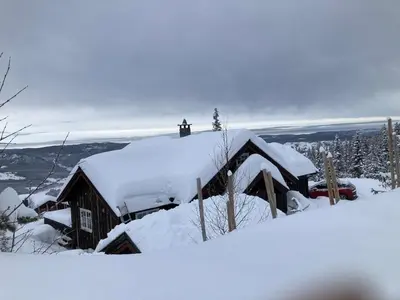 a house covered in snow with a roof at Skarvegløtt Ski in Ski out in Nesbyen
