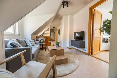 a living room with a couch and a tv at 3BR loft-apartment near Downtown & Ocean in Bergen