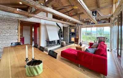 a living room with a red couch and a fireplace at Beautiful Home In Røn With Sauna in Ron