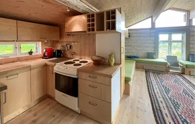 a kitchen with a refrigerator and a stove top oven at Beautiful Home In Røn With Sauna in Ron