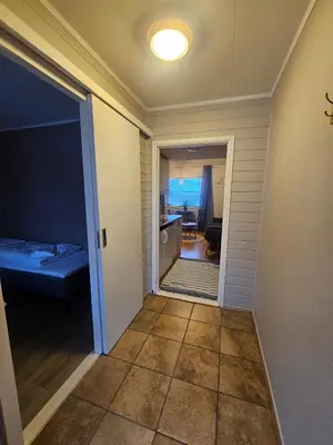 a hallway with a door leading to a kitchen and a room at Atlanten Turistsenter in Kristiansund