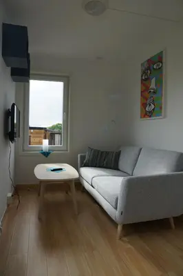 a living room with a couch and a table at Atlanten Turistsenter in Kristiansund