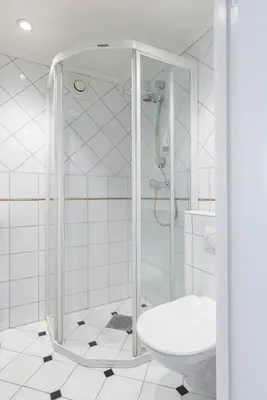 a bathroom with a shower and a toilet at Nice apartment with stunning view over Bryggen in Bergen