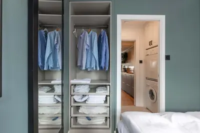 a walk in closet with blue shirts and towels at Nice apartment with stunning view over Bryggen in Bergen